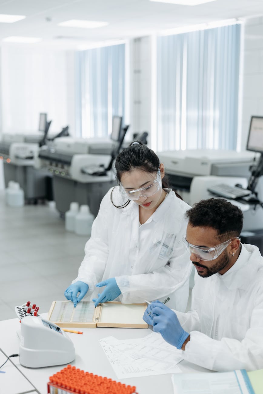 Two scientists in a lab working together on research, surrounded by modern equipment.